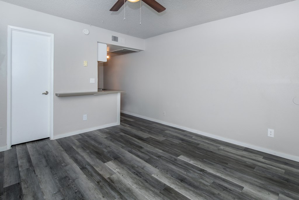 a living room with hardwood floors and a ceiling fan