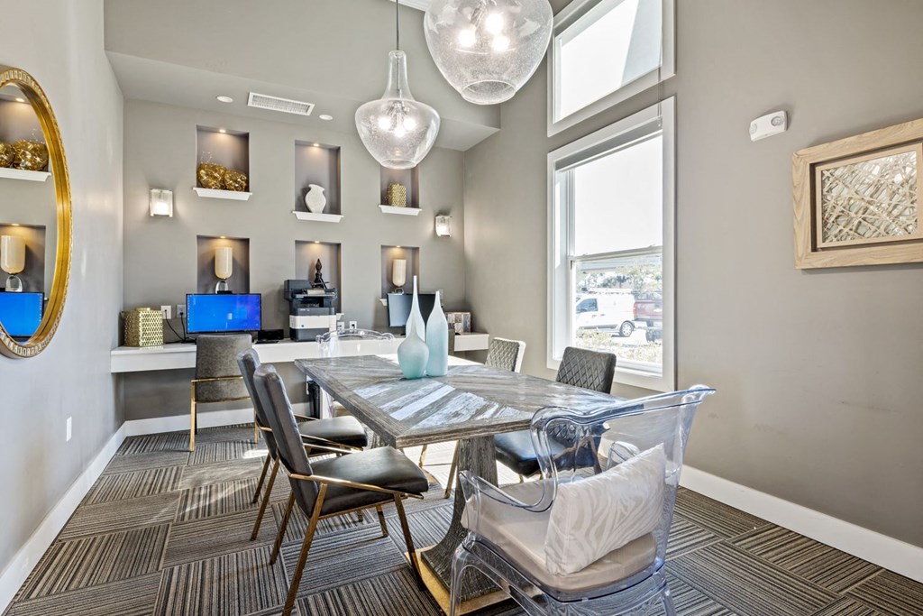 A dining room with a table and chairs.
