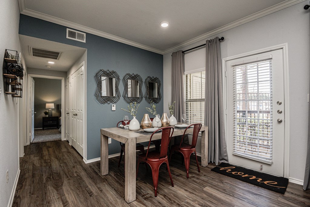 an image of a dining room with a table and chairs