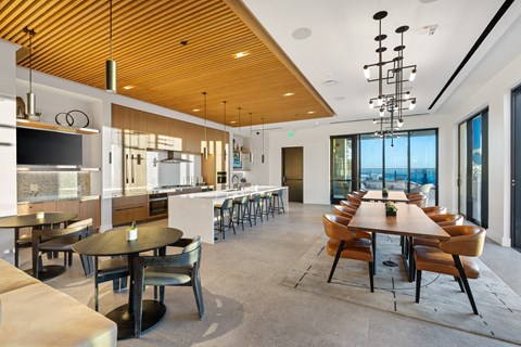 A modern dining room with a long table and chairs.