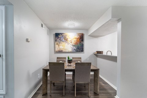 a dining room with a wooden table and chairs