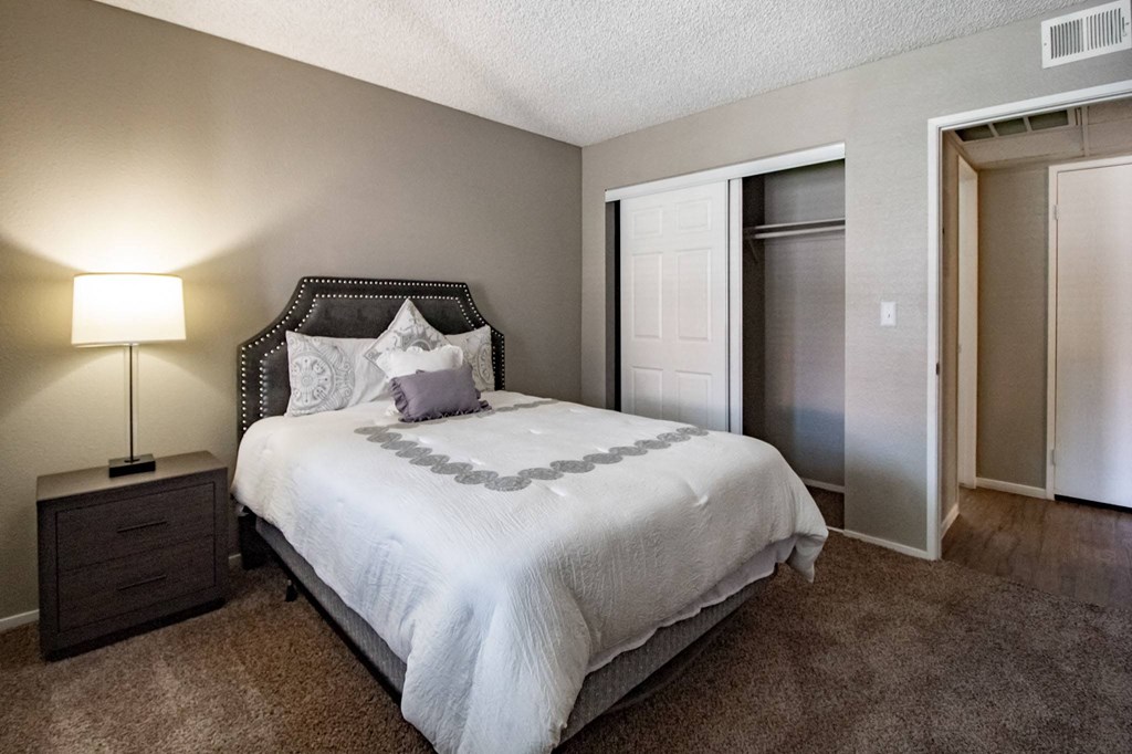 a bedroom with a bed and a closet