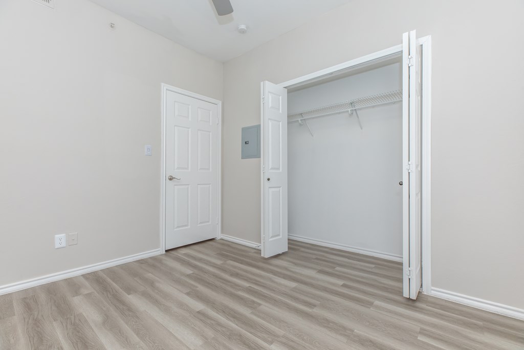 a bedroom with a closet and an open door