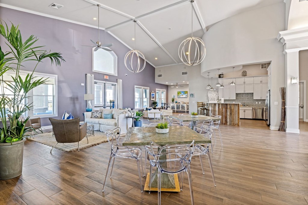 A modern dining room with a glass table and chairs.