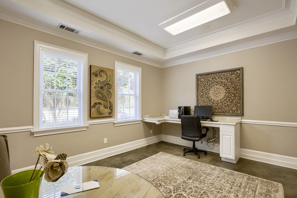 a home office with a desk and a computer in the corner