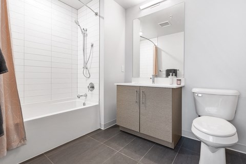a bathroom with a toilet and a sink and a shower
