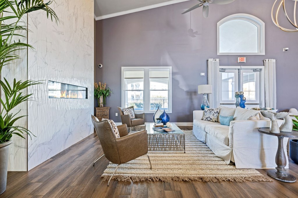 A living room with a brown chair and a white couch.
