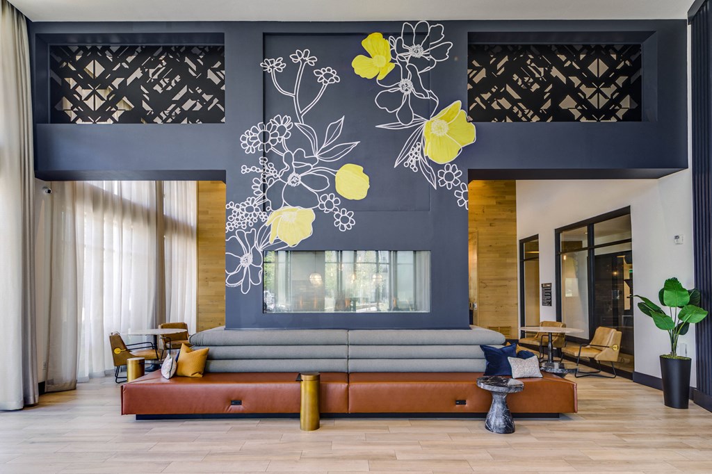 a living room with a blue wall and a couch and a large window