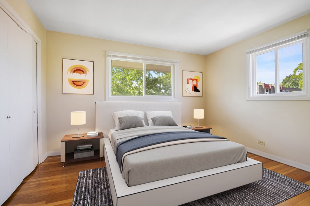 a bedroom with a bed and two windows
