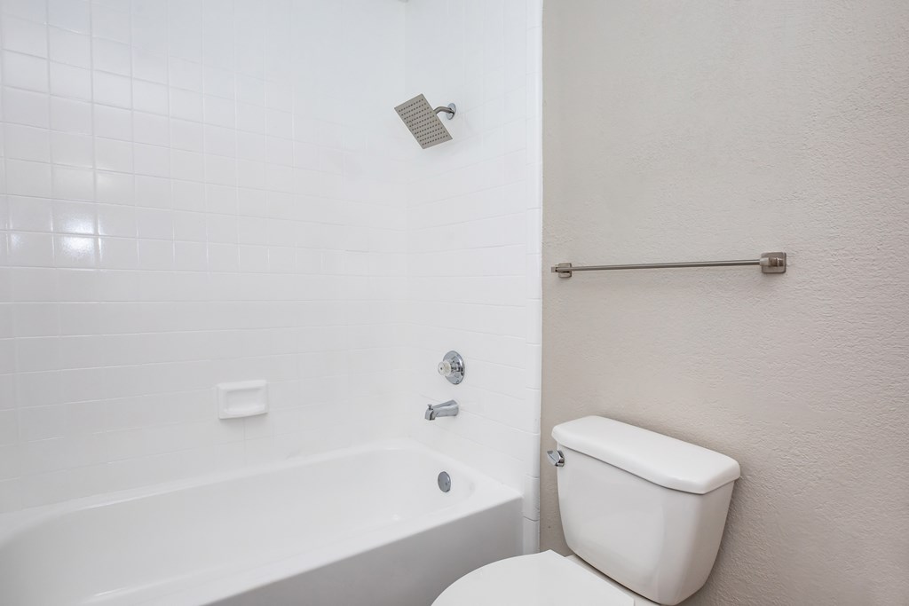 a bathroom with a tub and a toilet