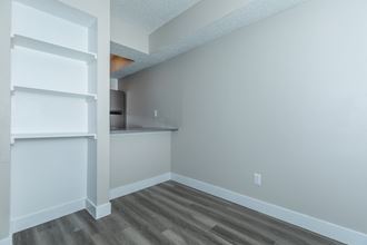 an empty room with a counter and shelves