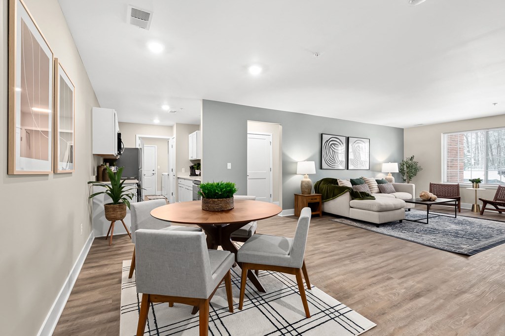 an open living room and dining room with a table and chairs