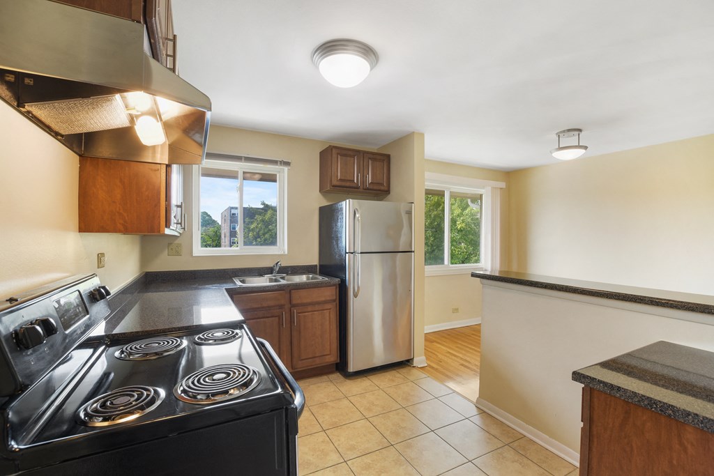 Spacious kitchen with stainless steel appliances and wood cabinets