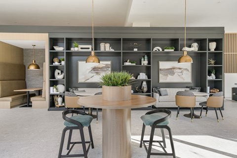 A modern living room with a dining table and chairs.