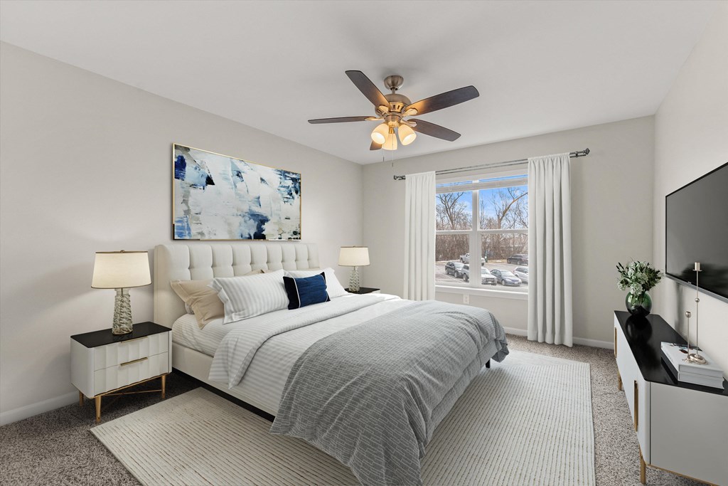 a bedroom with a bed and a ceiling fan