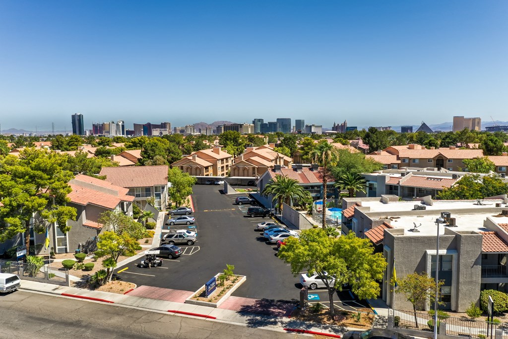 a city street with houses and a city skyline in the background