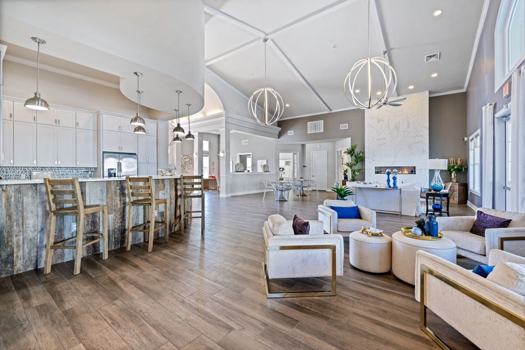 A modern living room with a bar area and a kitchen in the background.