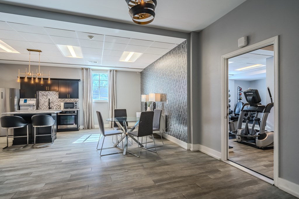 a conference room with a table and chairs and a mirror