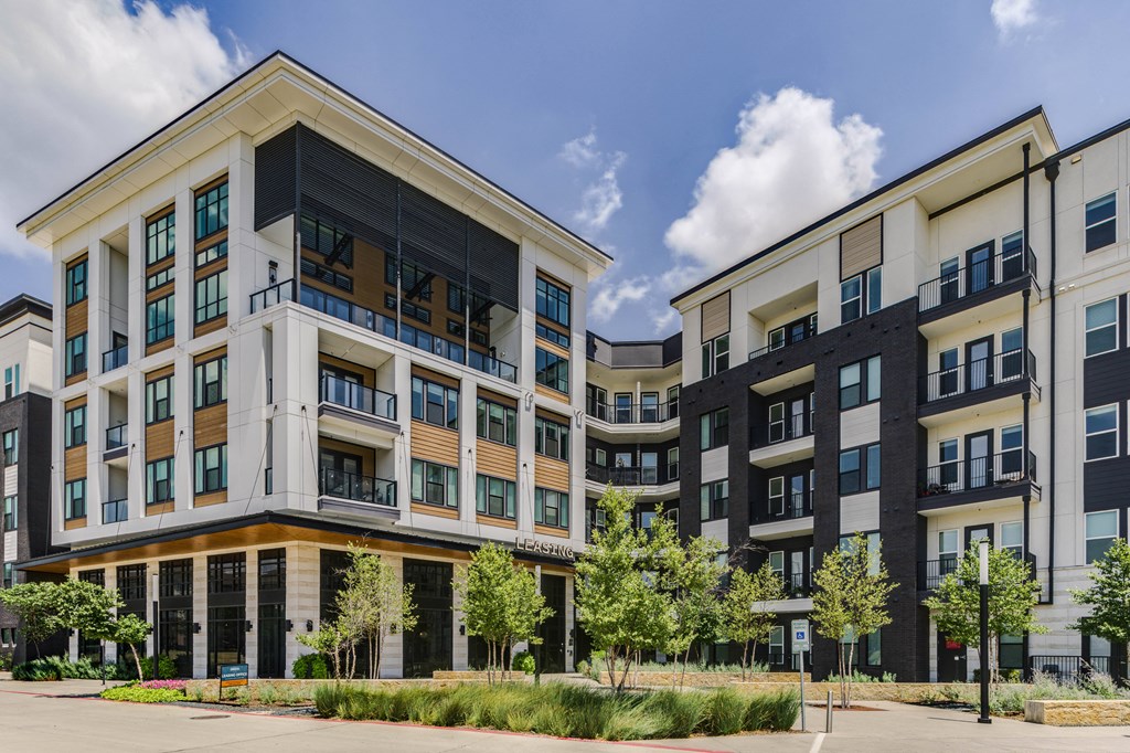 a large apartment building with a street in front of it