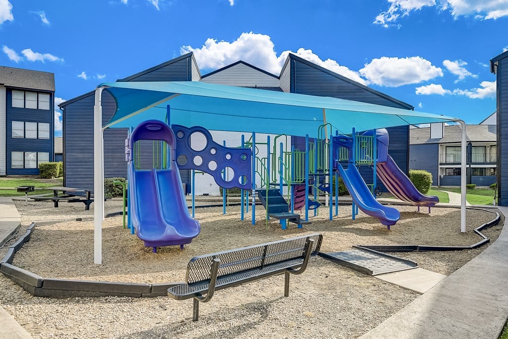 a playground at the enclave at woodbridge apartments in sugar land, tx