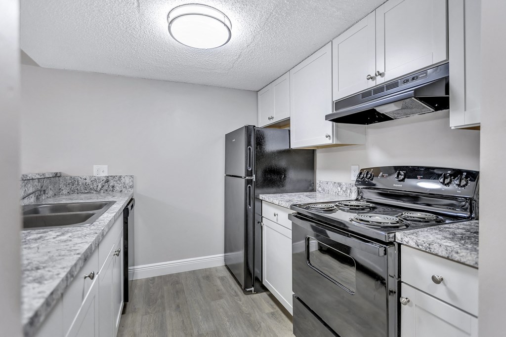 a kitchen with stainless steel appliances and white cabinets
