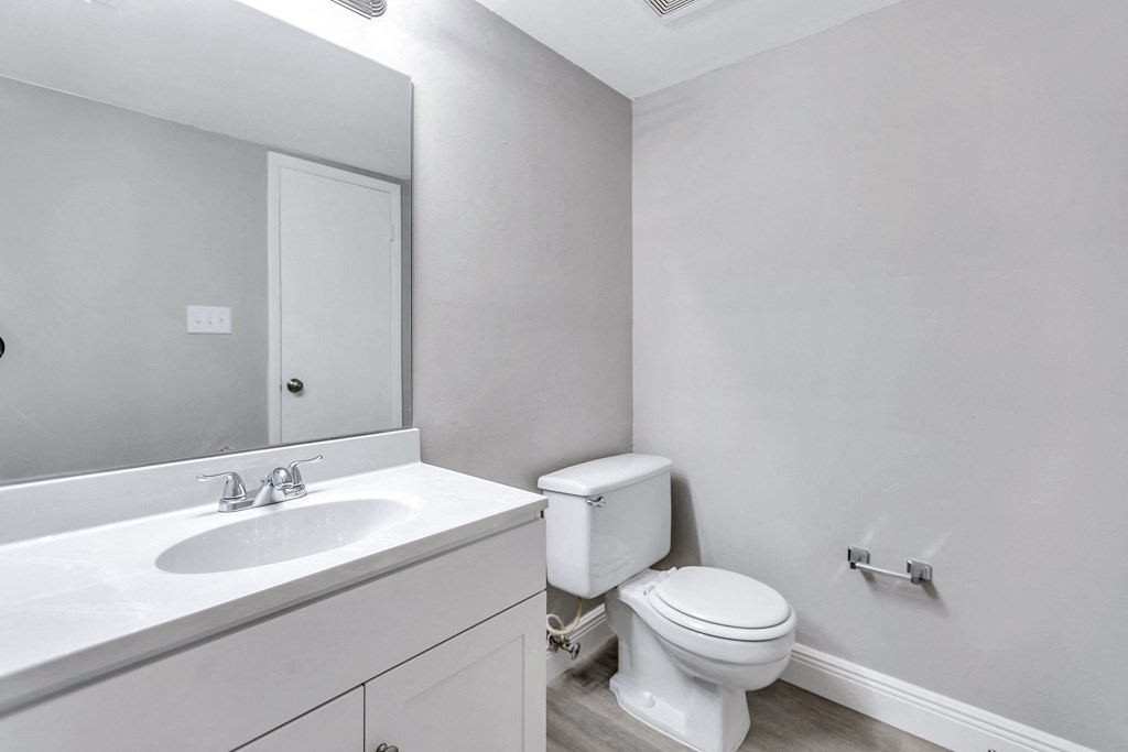 an empty bathroom with a toilet and a sink