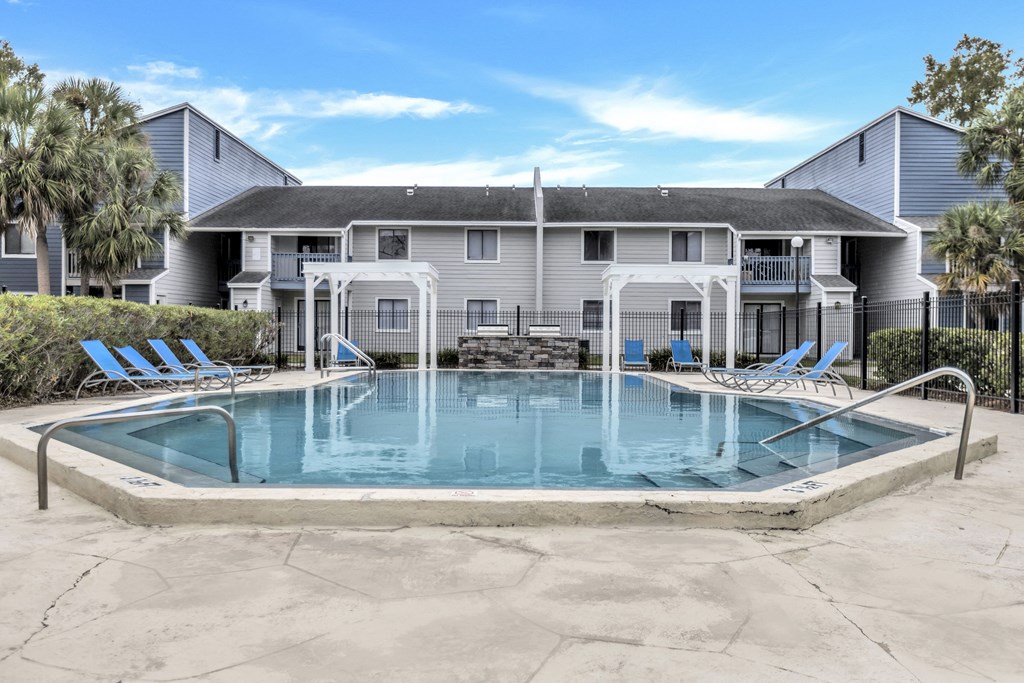 a swimming pool with a house in the background
