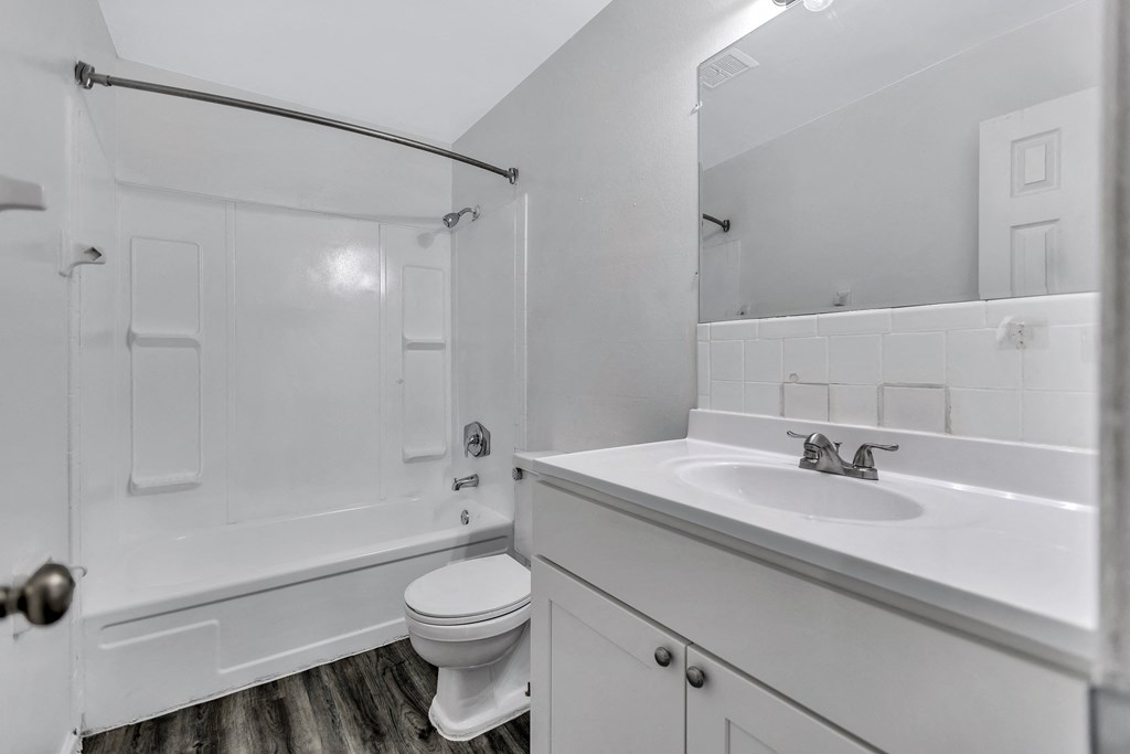 an empty bathroom with a sink toilet and shower