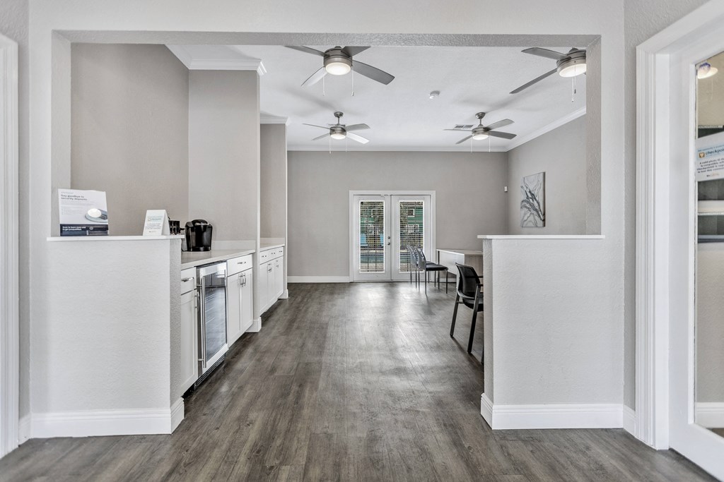 a kitchen and dining room area with white appliances and a ceiling fan