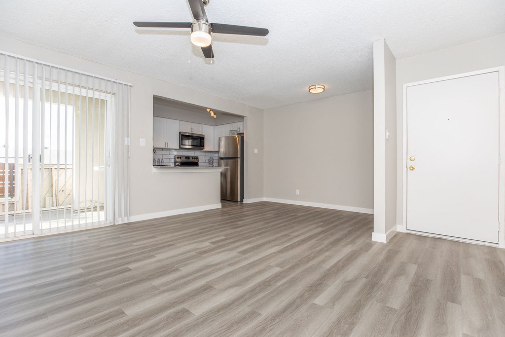 a living room with hardwood floors and a ceiling fan
