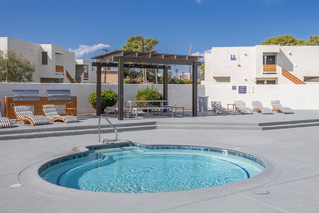 a swimming pool at a resort unit with a hot tub