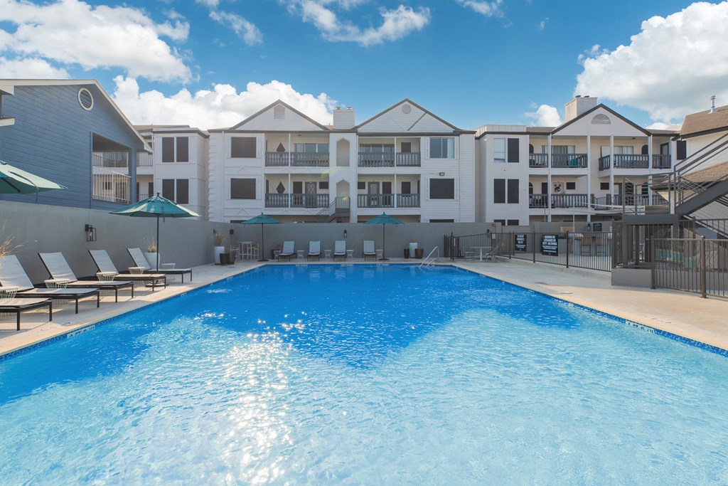 a large swimming pool with a building in the background