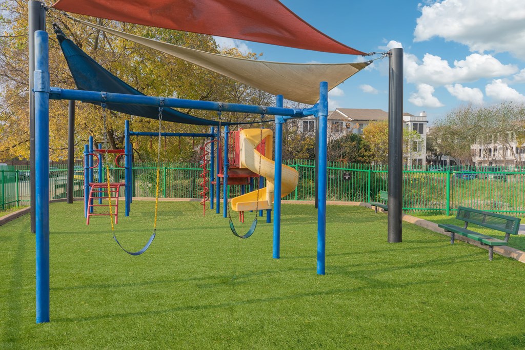 a playground with a swing set and a slide