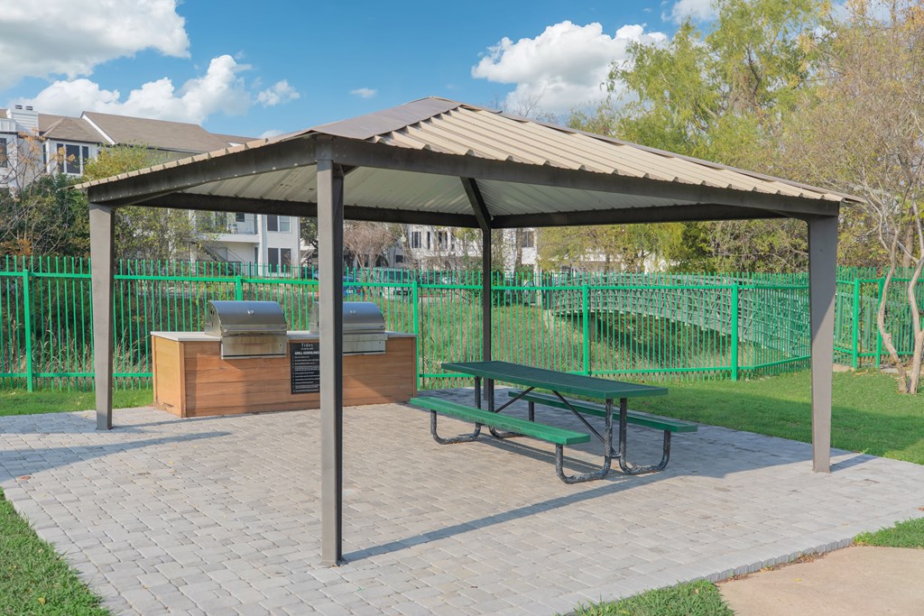 a picnic area with a picnic table and a gazebo