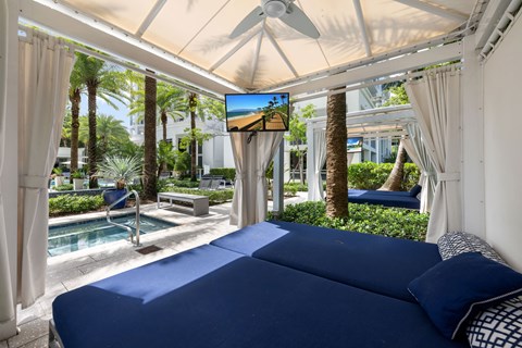 a bedroom with a bed and a view of a pool and palm trees