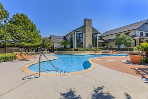 a swimming pool with a building in the background