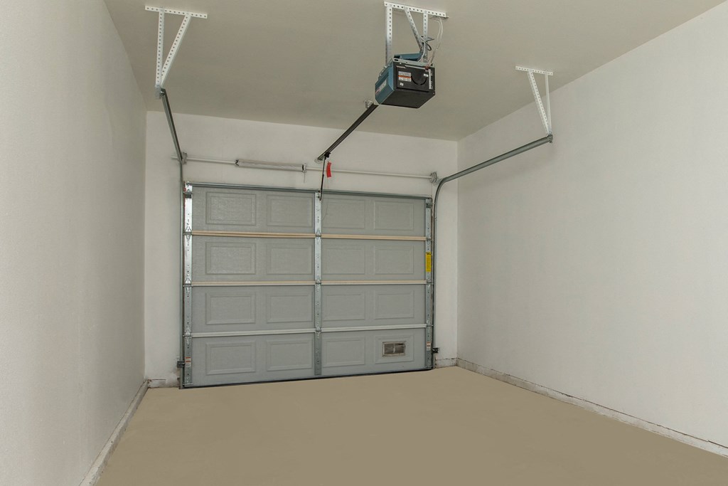 a garage with a garage door and a tv on the ceiling