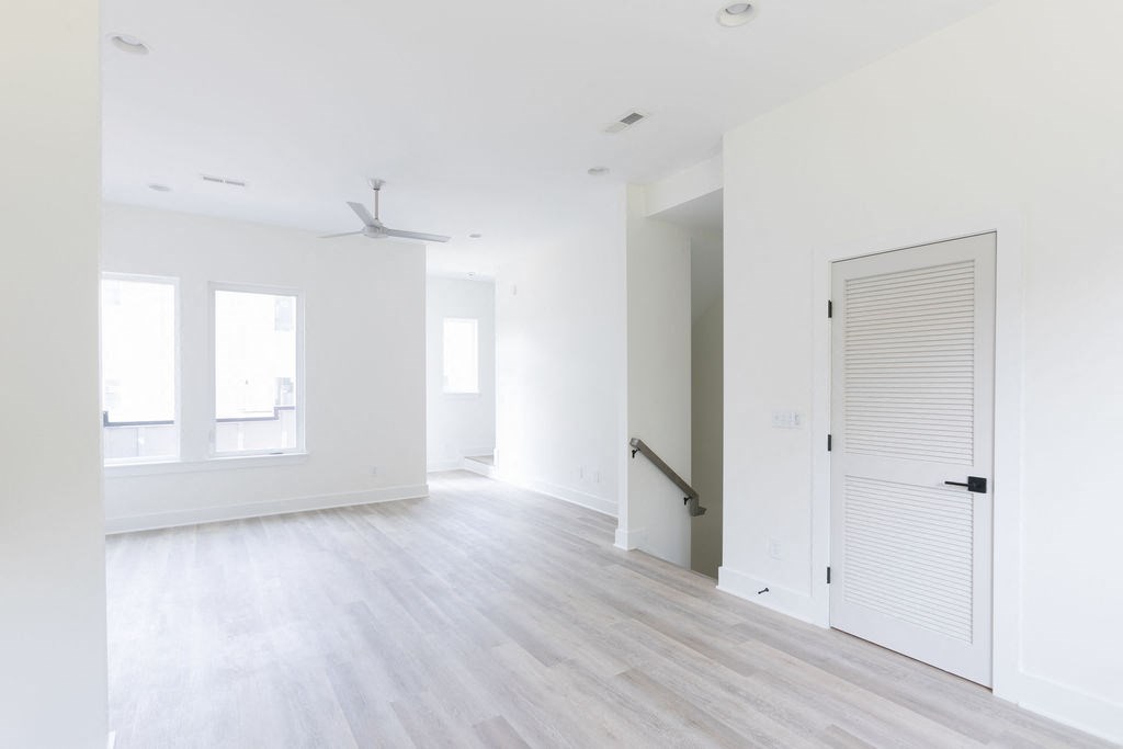 an empty room with a white door and white walls