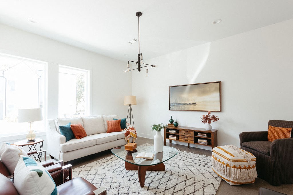 a living room with white walls and a white couch