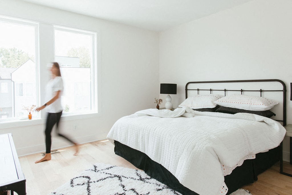 a bedroom with a bed and a window