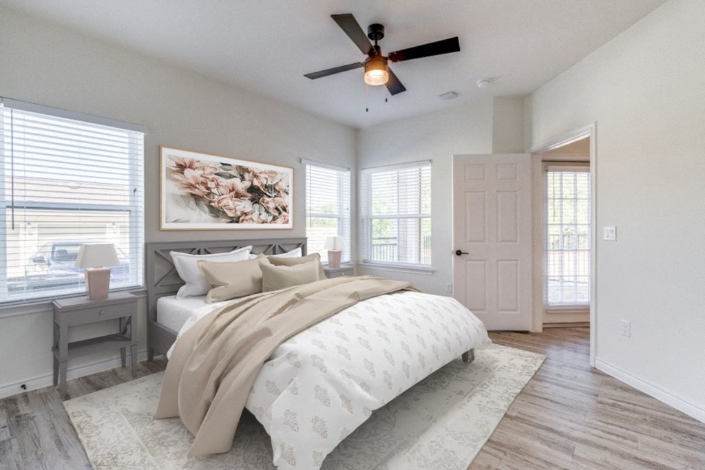 an empty bedroom with a bed and a ceiling fan