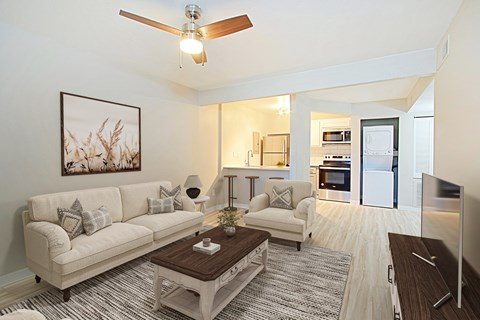A living room with a white couch and a coffee table.