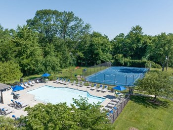 Drone shot of community featuring the pool and tennis court. - Photo Gallery 11