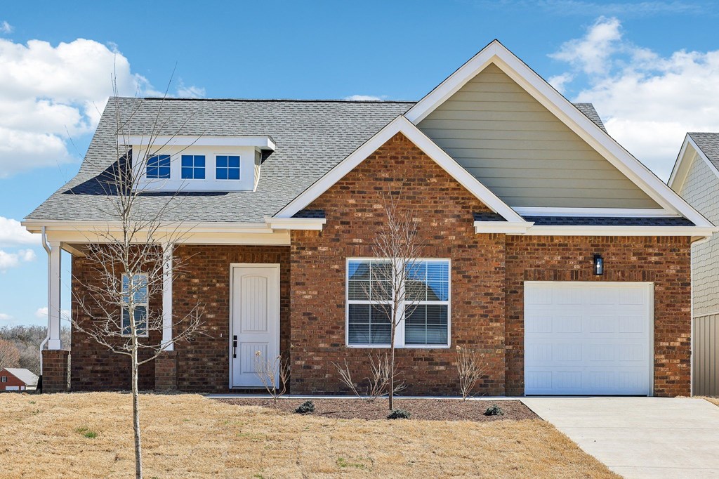 A house with a white door and a garage door.