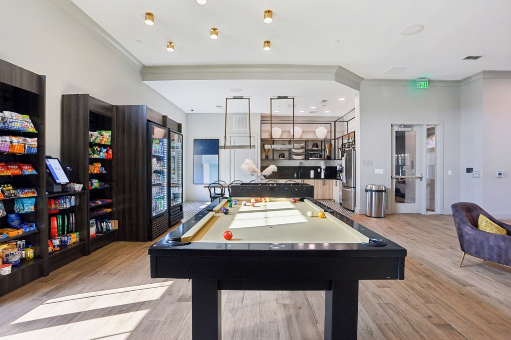 A billiard table is in the middle of a room with a pool table light.