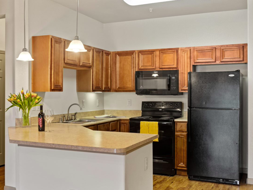 a kitchen with wood cabinets and black appliances