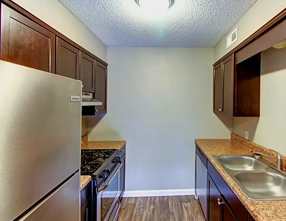 a kitchen with a stove top oven next to a sink