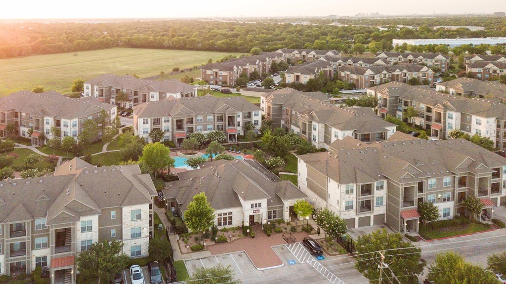 an aerial view of a neighborhood with houses and a swimming pool