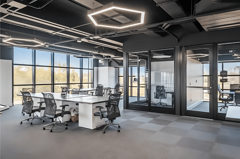 A modern office space with a large desk and chairs.
