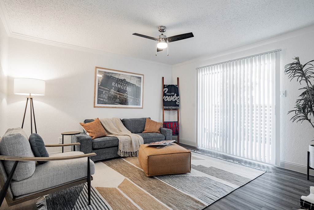 our apartments offer a living room with a couch and a ceiling fan